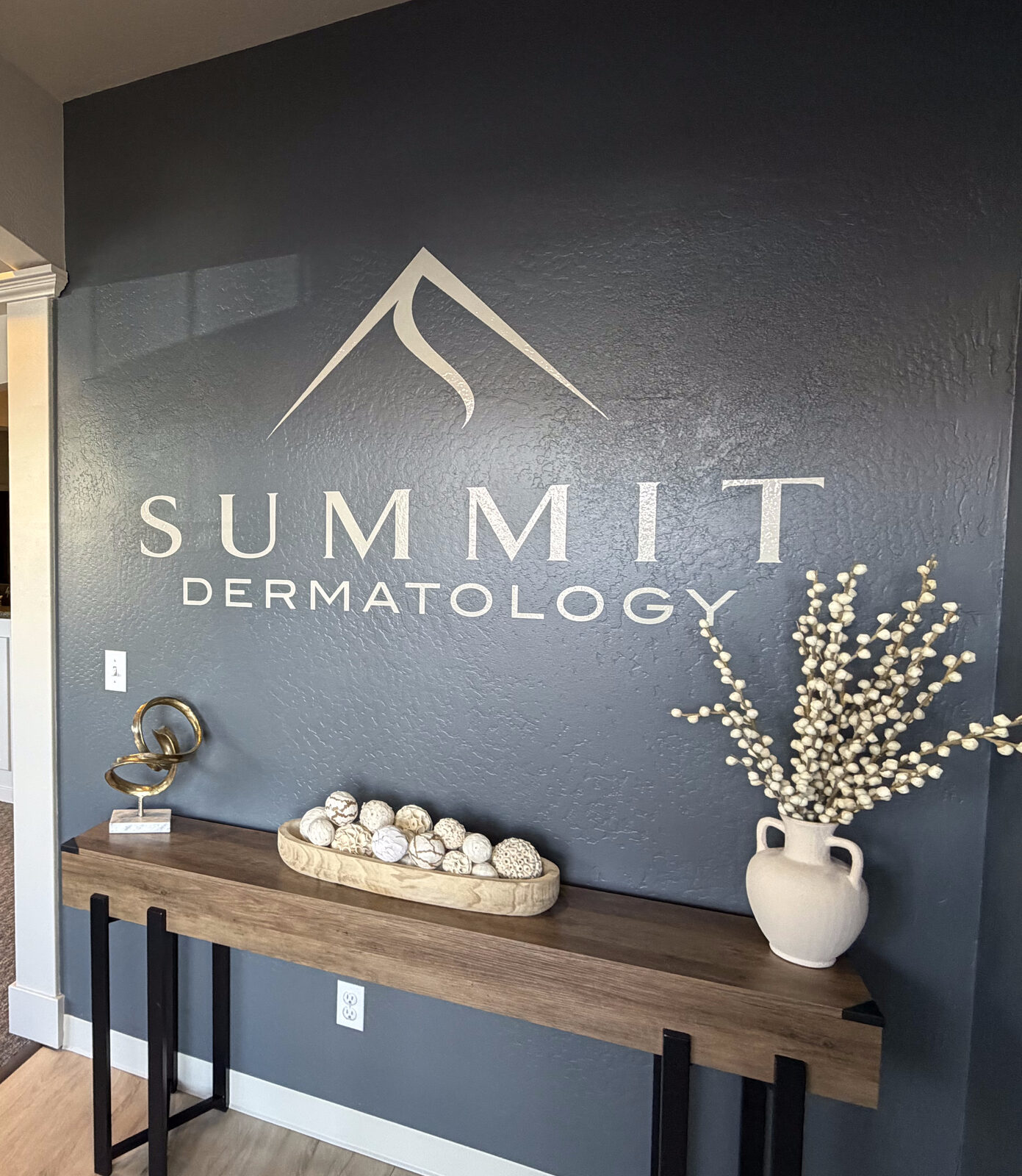 Summit Dermatology lobby with brand logo wall