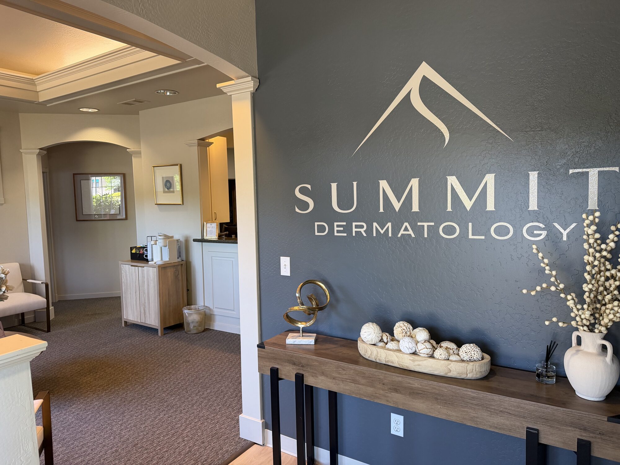 Summit Dermatology & Aesthetics reception and brand logo wall